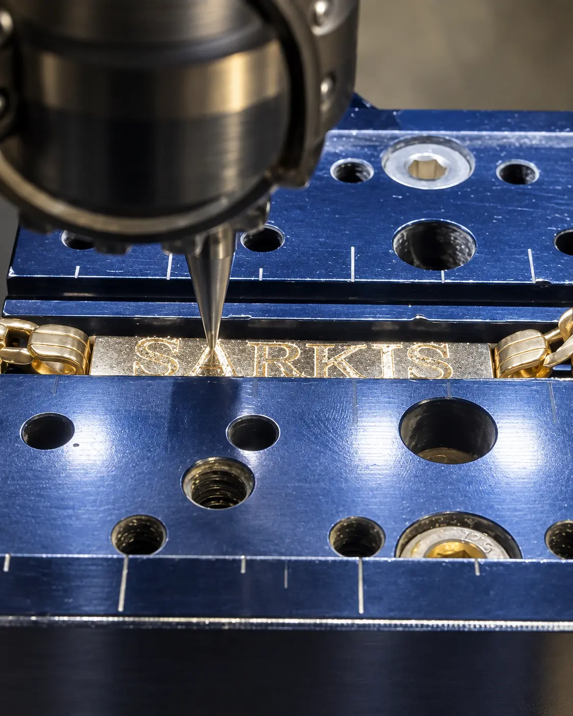Personalized gold bracelet being engraved at the jeweler's bench