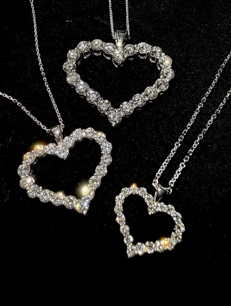 Diamond heart pendant necklaces on display