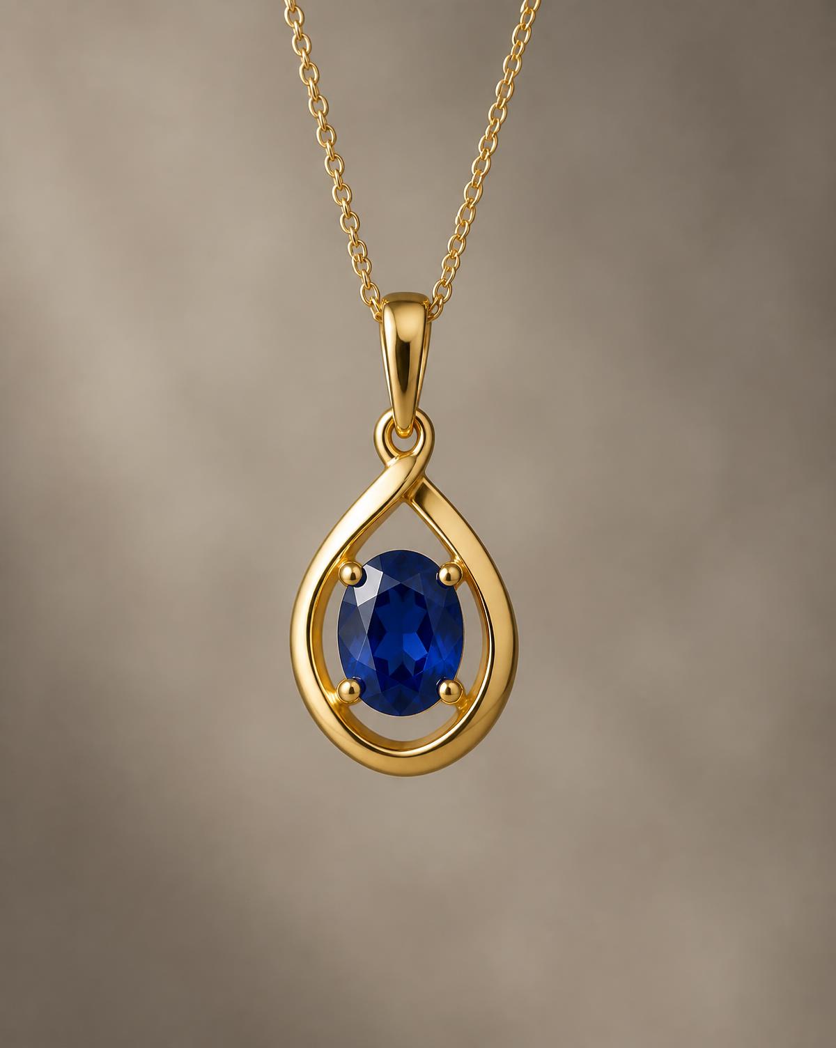 Gold pendant set with a blue sapphire